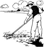 A man using a cultivator in a field.