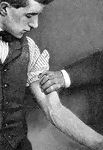 "Showing how firm pressure may be made with the fingers to compress the branchial artery of the left arm. Some large superficial veins are also shown." &mdash; Blaisedell, 1904