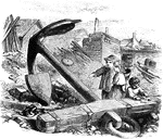 Two children are standing near an anchor nearly twice as tall as they are. The anchor is on the shore. A third child uses the anchor as a table for small objects.