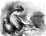 A woman sits with a child on her lap. The child is wearing a frilly dress and playing with the woman's necklace.