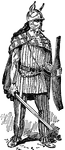 A soldier from Gaul carrying a sword in his right hand and shield in his left. He is wearing a cloak and traditional braccae, trousers made from wool. The trousers are fitted around the ankle. The soldier's helmet has horns and ear-pieces. He has long hair and a long mustache.