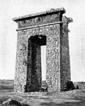 A monumental gateway, usually between two towers in outline like truncated pyramids.