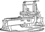 "The ordinary self-acting planing machine. Its action bears no resemblance to the familiar process of wood planing, but is analogous to that by which the successive cuts of a narrow tool produce a cylindrical surface in a slide lathe. A transverse table carries the work and forces it against the tool, which is stationary while making its cut, but between the cuts has a slight "feed" motion along its horizontal slide." &mdash;The Encyclopedia Britannica, 1903