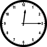 Round clock with numbers showing time 12:15