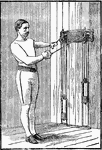 A man exercising with chest weights. In this position, he is pulling down with his left arm and across with his right, then switch.