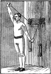 A man exercising with chest weights. In this position, he is moving his arms out at the same time, directly forward.