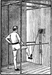 A man exercising with the stirrup. This device is used for leg exercises.