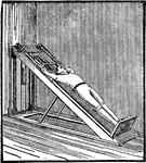 A man exercising with the long inclined plane, used for the upper body.