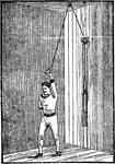A man exercising with the giant pulley, used for chest and arms.