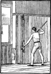 A man exercising with the paddling machine, high attachment.