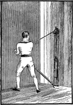 A man exercising with the sculling machine, used for the upper body.
