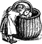 A child putting something in a large basket.