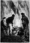 Three men gathered closing around a small fire.