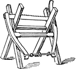 A wood-saw hanging on a sawhorse, which is a legged beam to support a piece of wood while sawing.