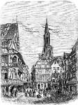 Street scene in Strasburg with public square in the foreground and a church spire in the background.