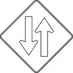 A Two-Way Traffic sign should be used to warn road users of a transition from a multi-lane divided section of roadway to a two-lane, two-way section of roadway.
