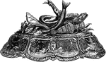 This inkstand is ornamented with a group of fish at the top.