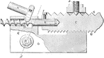 A spiral milling apparatus for a lathe to create drills and flutes. The working surface is fastened to the lathe by the bolt on the left. While the rod is spinning, a spindle is inserted in a hole at a desired angle.
