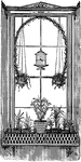 A window with an ivy trellis, or a structure to support plants.