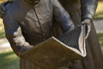 A Book in the Hands of Two Bronze Figures
