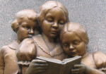A Boy and Two Girls Reading a Book at Base of William McGuffey Memorial