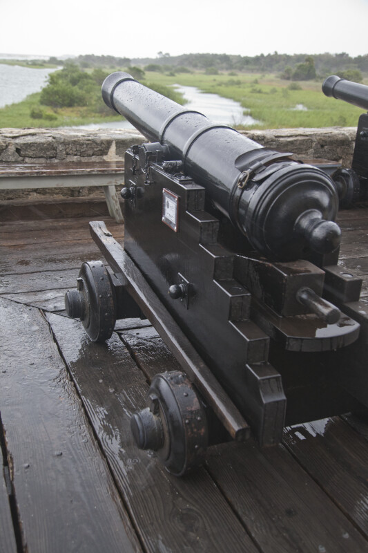A Cannon on a Wet, Wood Deck