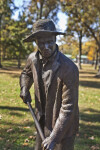 A Close-Up of a Bronze Sculpture Depicting a Farmer