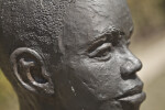 A Close-Up of the Face of a Bronze Figure Depicting a Young Boy at Corinth Contraband Camp