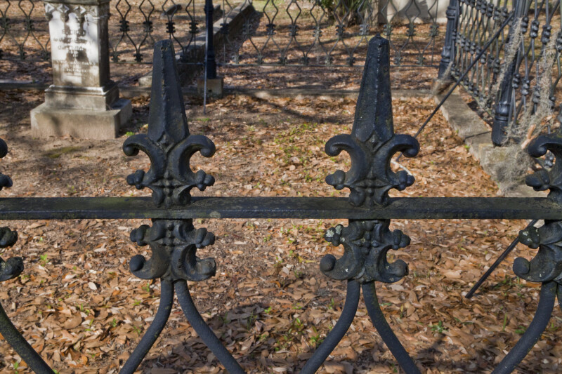 A Closer View of a Metal fence around a Cemetery Plot