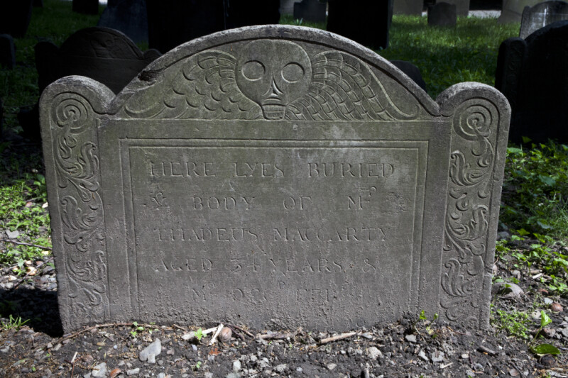 A Death's Head on a Shouldered Tablet Headstone