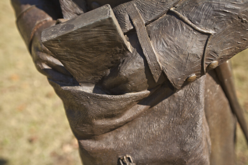 A Detailed View of the Sleeve of a Bronze Sculpture