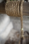 A Fiber Rope Wrapped around a Wooden Well Crank