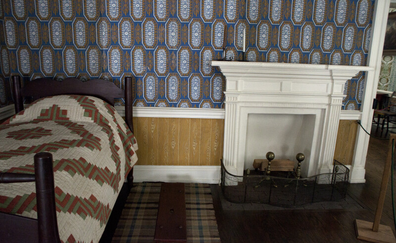 A Fireplace Screen by the Bed