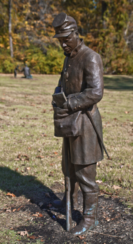 A Full_Length View of a Bronze Sculpture of a Soldier