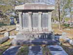 A Large Cap, Die, and Base Headstone with Three Ground Ledgers