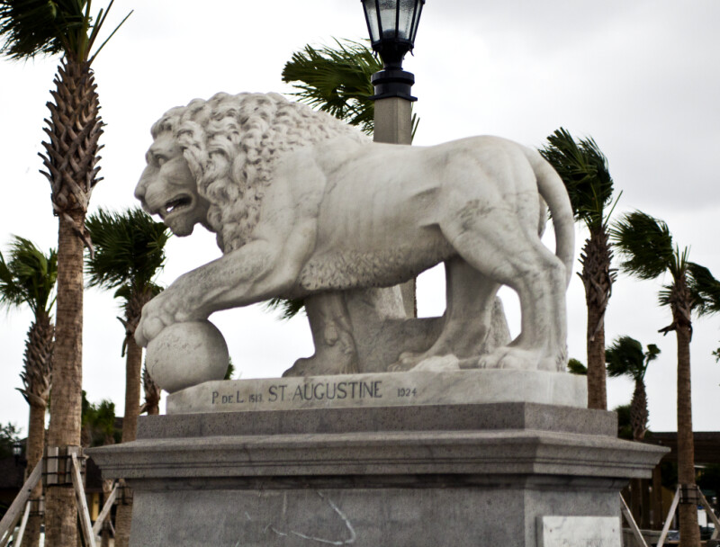 A Marble Sculpture of a Lion with a Ball