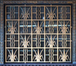 A Metal Grille, with Plant Motif, Covering a Window