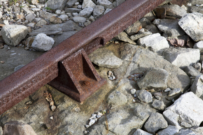 A Rusted, Metal Rail Seated in a Cast Iron Chair
