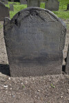 A Slate Headstone with A Death's Head Carving