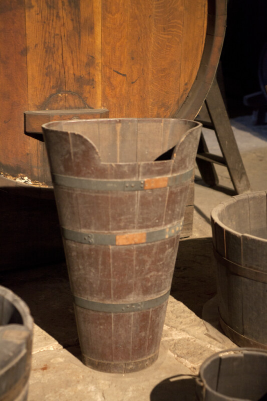 A Wooden Bucket with A Large Notch in the Lip