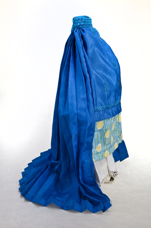 Afghanistan Woman Wearing Blue Silk Burqa Over Pajami (Side View)