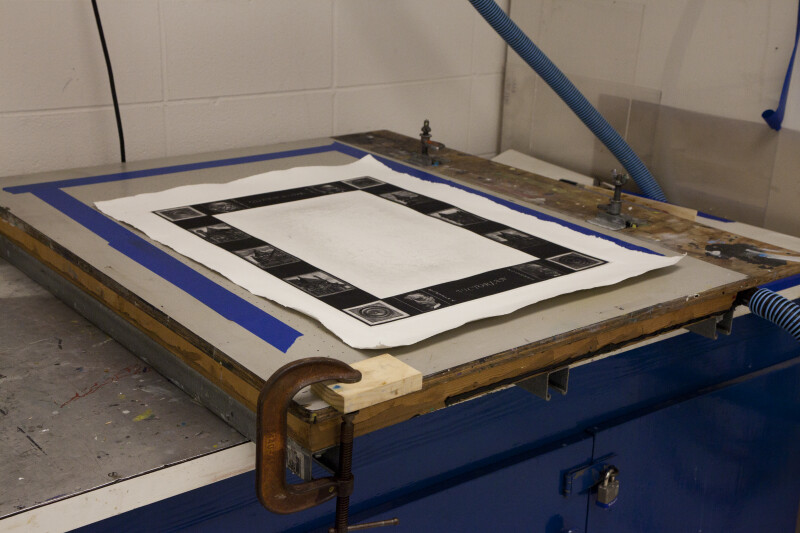 An etching print sitting on a screenprinting vaccum table.