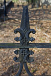 An Even Closer View of a Metal Fence around a Cemetery Plot