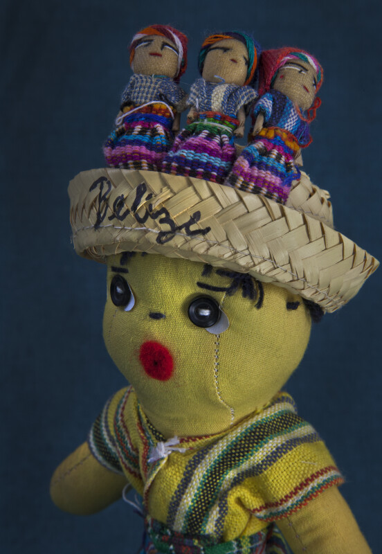 Belize Male with Straw Basket and Worry Dolls on His Head (Close Up Dark Background)