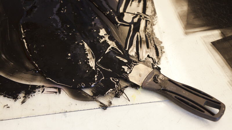Black ink on an inking slab.