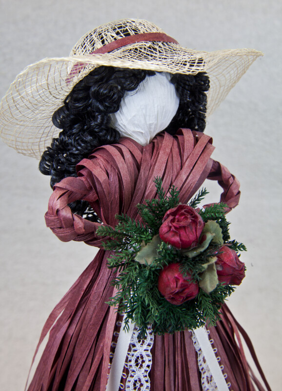 Canada  Handcrafted Doll with Straw Hat, Artificial Bouquet of Roses, and Dress Made from Ribbons (Close Up)