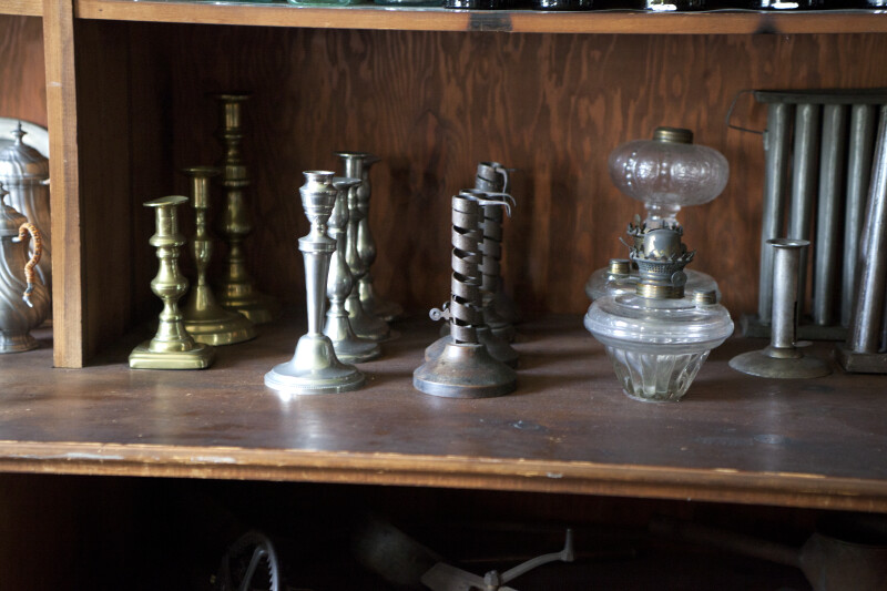 Candlesticks and Lamps on a Shelf