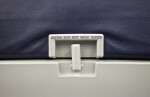 Collapsible Table and Seat Belt Warning Sign on Airplane