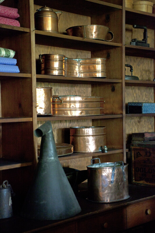 Copper Pots and Other Goods on Shelves