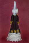 Doll Wearing Cone-Shaped Hat and Velvet Coat Trimmed in Gold (Back View)
